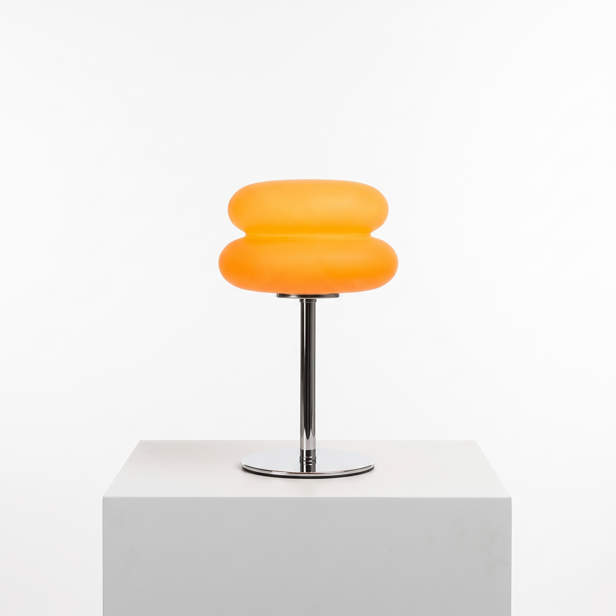 Bauhaus Macaron Table Lamp in Orange on a white display plinth
