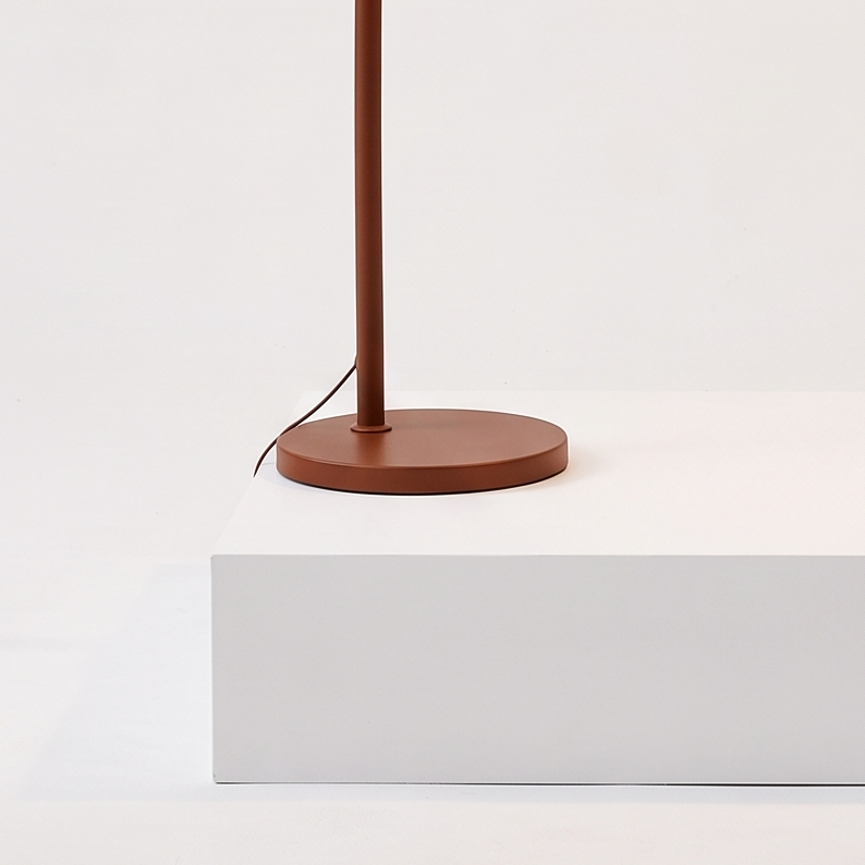 Mid-Century Arc Floor Lamp with Amber Dome on a white display plinth, detail view