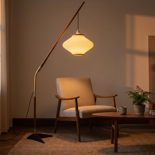 Wabi-Sabi Pine Bell Floor Lamp, switched on in a cozy interior at dusk