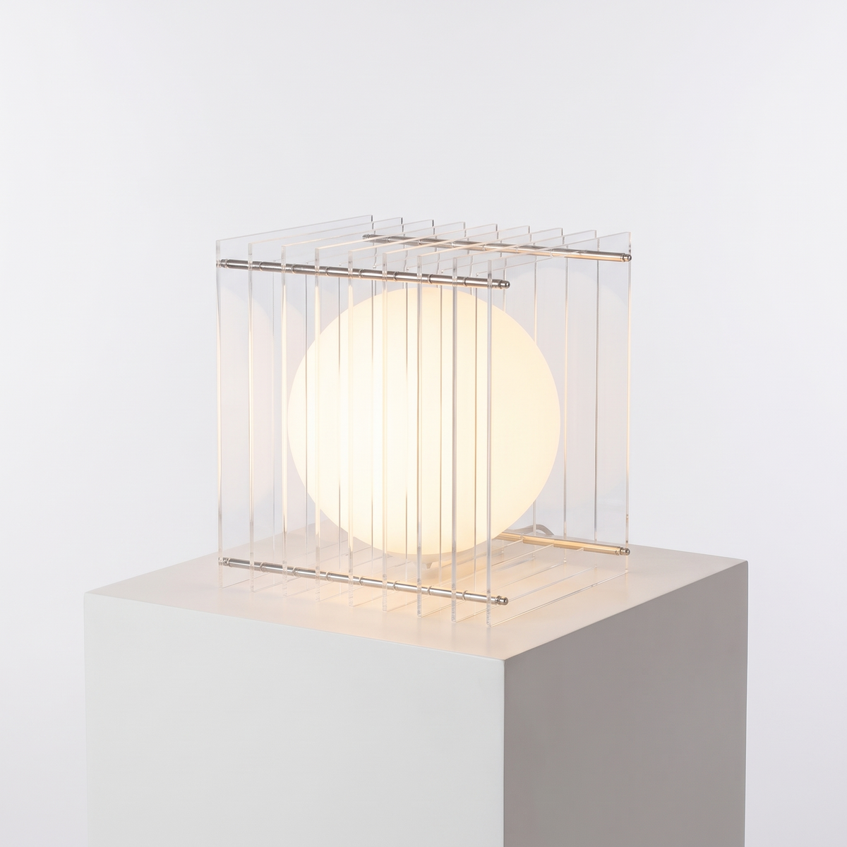 Acrylic Cube Sphere Night Light in Clear on a white display plinth