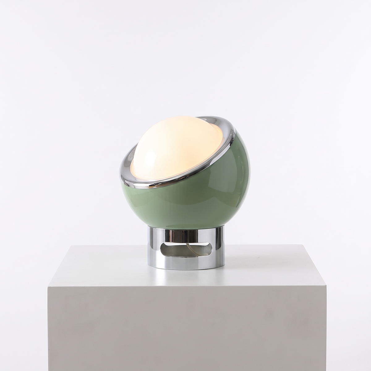 Space Age Egg Table Lamp in Green on a white display plinth