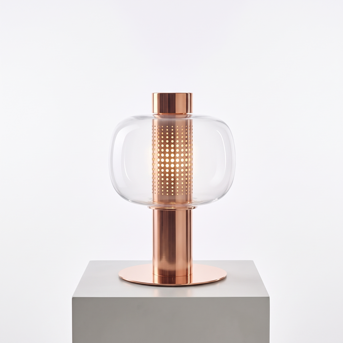 Mid-Century Bedside Table Lamp in Type E, clear glass with copper base on a white display plinth