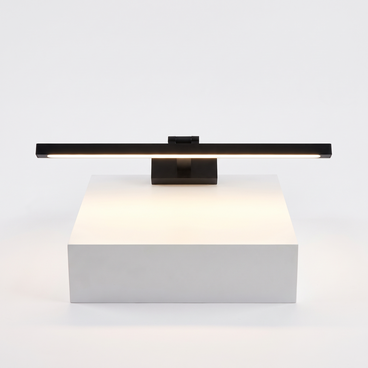 Brass LED Picture Light on a white display plinth, full view
